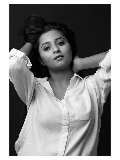A classic portrait where the wind adds a touch of life. The black and white conversion brings out the texture of her hair and the honesty in her expression, resulting in a simple yet captivating headshot.