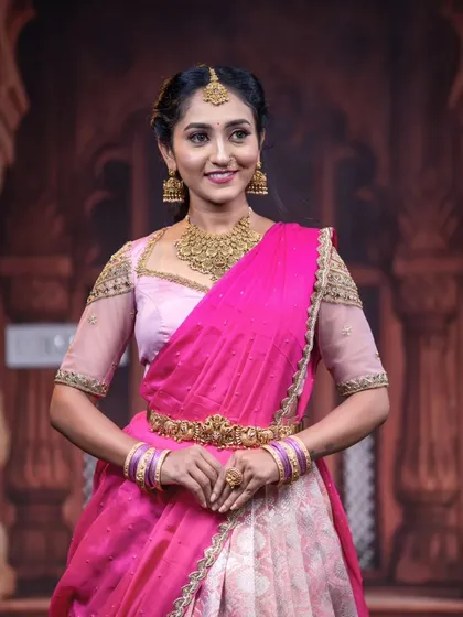 Another full-length view of the model in the pink half saree, showing her poised and elegant.