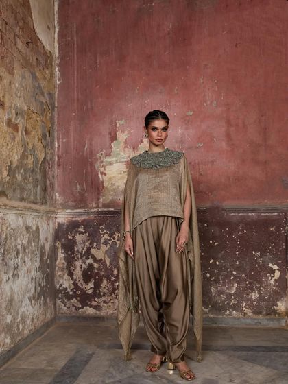 A full-length shot of a model in a dhoti-style cape set, showcasing the unique and fluid silhouette.