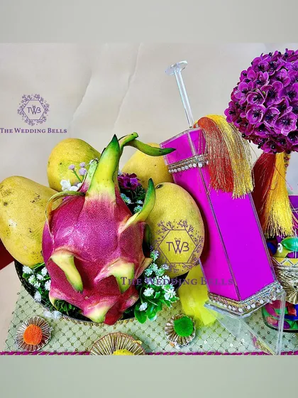 The combination of fresh fruits and festive elements makes this Holi hamper a unique and healthy gifting option.