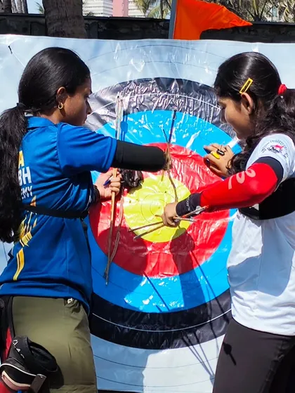 Two girls scoring their target together. Teamwork and sportsmanship are just as important as individual skill.