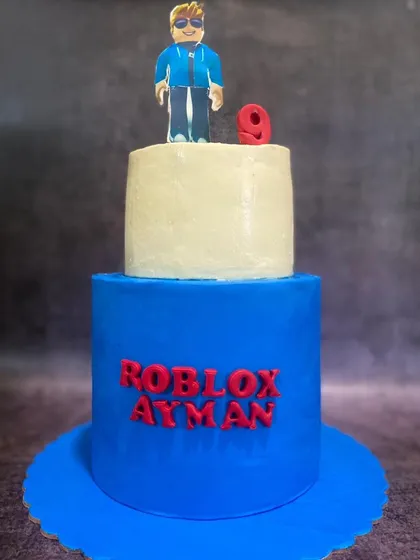 Bring on the fun themes! This two-tier Roblox cake was a blast to make for a 9th birthday. The bottom tier is a vibrant blue, with the birthday boy's name in the iconic Roblox font, and the top features a custom-made character topper.