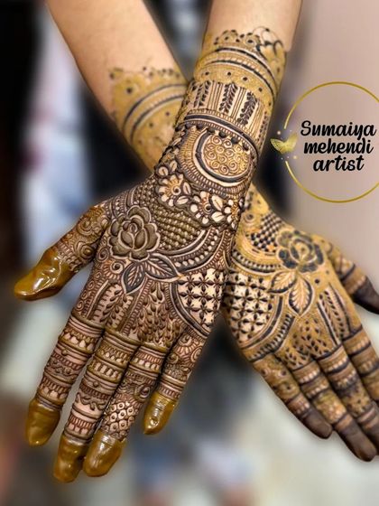 A beautiful Indian mehendi design with floral bands. The roses and other flowers are woven into the traditional patterns seamlessly.