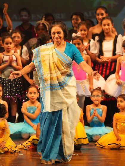 A special moment with one of our senior members on stage. Our community spans generations, and we cherish the wisdom and grace they bring to our annual show.