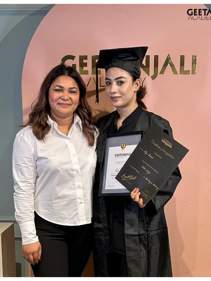 A graduate proudly holds her Geetanjali Academy and L'Oréal certificates. We equip our students with dual certification that holds immense value in the beauty industry.