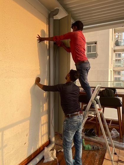 Here, our team is preparing a wall for the installation of a vertical garden or decorative paneling. This prep work is crucial for a clean and professional final look.