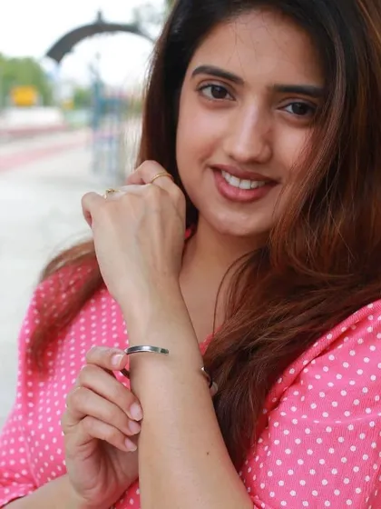 The woman smiles while wearing her personalized bracelet, showing the joy a piece of meaningful jewelry can bring.