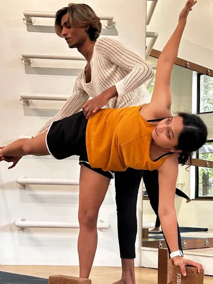 We brought Yoga classes back to bring more balance and calm into our training. A qualified instructor guides a member through a pose, providing hands-on correction to deepen the stretch and ensure proper alignment.