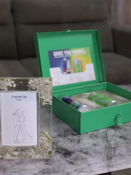 Another look at the Red Bull PR package, with the custom resin frame displayed next to the branded box.