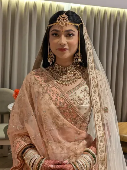 The full look with the dupatta set over the floral hairstyle.