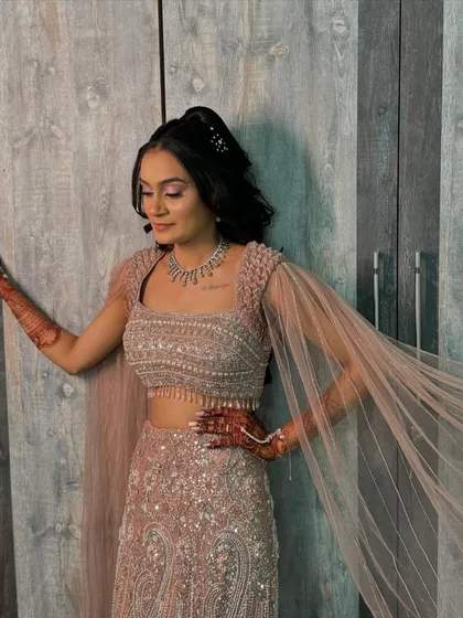 Her sparkle is in her eyes. For her sangeet, we created a look with dramatic, smoky eyes and a high ponytail, ensuring she would stand out.