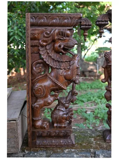 A side view of the 36-inch Yaazhi and elephant bracket. This angle shows the powerful interaction between the two creatures, a classic theme in temple carving.