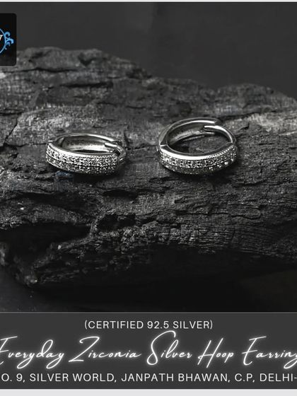 Another view of our everyday zirconia silver hoop earrings, showing the detail of the stones and the secure clasp mechanism.