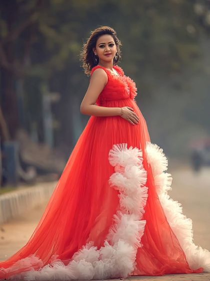 When grace meets boldness. This modern muse slayed her outdoor maternity shoot in a flowy, fire-red couture gown.