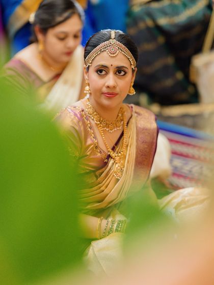 A candid moment during the ceremony, her expression serene and her makeup looking flawless and traditional.