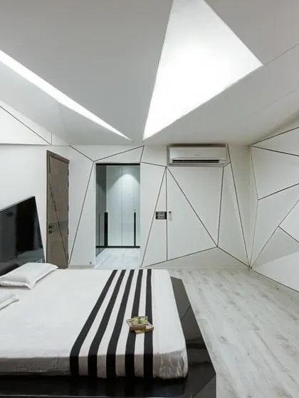We pushed the boundaries of bedroom design with this deconstructivist concept. The interplay of geometric lines on the walls and ceiling creates a dynamic, sculptural space, while the monochrome palette maintains a sense of sophisticated calm.
