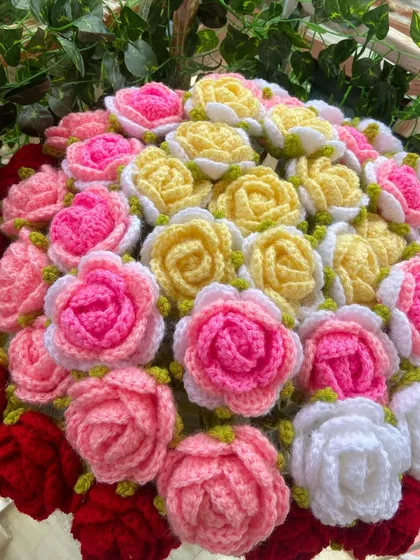 A stunning multi-colored rose bouquet, featuring red, pink, yellow, and white blooms.
