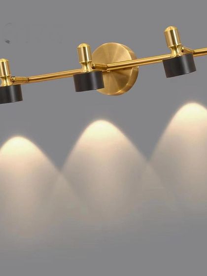 A three-headed spotlight fixture, perfect for providing directional light in a kitchen, study, or to highlight a piece of art.