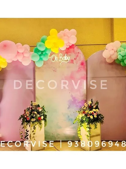 For a modern and chic baby shower, we created this pastel-themed backdrop. It features elegant arched panels with a watercolour finish, an "Oh Baby" sign, and organic balloon arches in a soft, playful colour palette.
