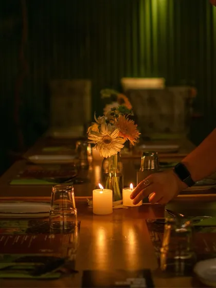 As evening falls, the glasshouse transforms. The soft glow of candlelight creates an intimate, almost magical atmosphere for our dinner services, turning a meal into a quiet, unforgettable memory.
