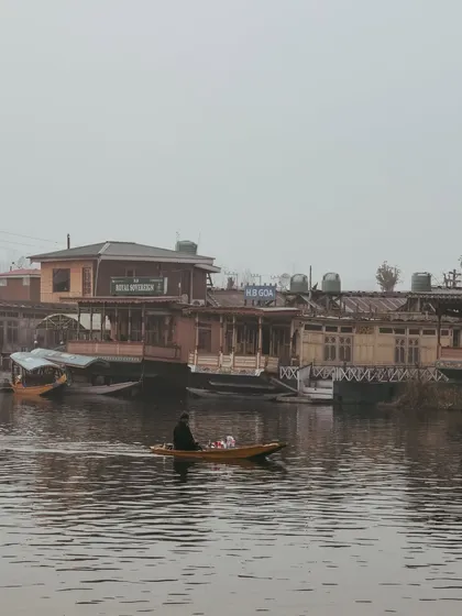 The houseboats of Dal Lake, standing silently in the misty morning. There's a story in every one of these floating homes.