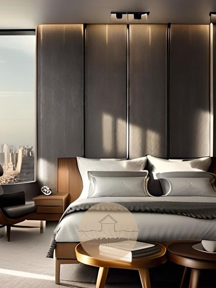 A stylish master suite that combines vintage-inspired furniture, like the leather lounge chair, with a modern, paneled headboard and integrated lighting for a timeless look.