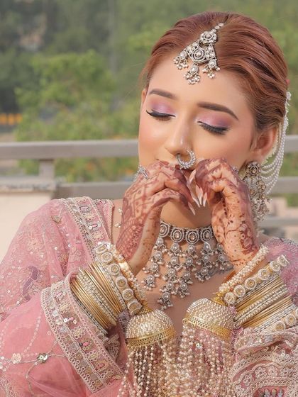 A beautiful shot of a bride with her eyes closed, showcasing the soft pink monochromatic eyeshadow. This look is all about creating a gentle, romantic feel that is perfect for a day wedding or engagement.