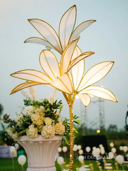 A unique lighting element designed for an elegant outdoor event. This custom-made floral lamp adds a touch of artistic and whimsical light to the decor.
