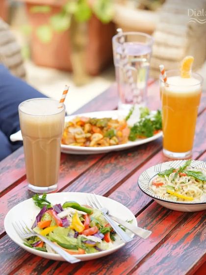 A table full of deliciousness. From fresh salads and creamy pastas to our signature garlic paneer, there's something for everyone to enjoy.