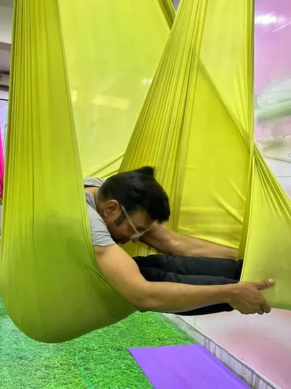The body achieves what the mind believes. A student holds a compact, cocoon-like pose, which is excellent for calming the nervous system and practicing mindfulness.