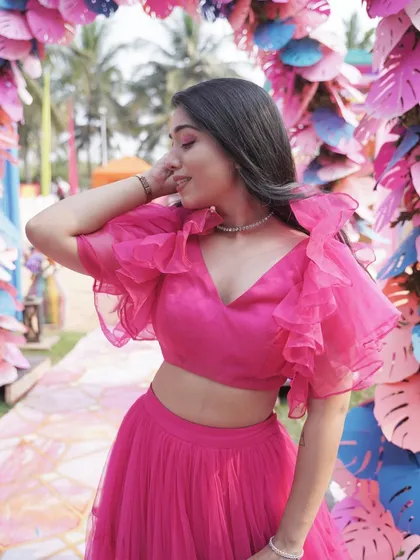 A close-up shot showcasing the details of my pink outfit and the happy vibe of a daytime wedding event.