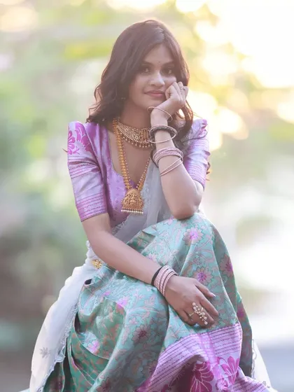A classic seated portrait. The model's pose is relaxed and elegant, and the backlighting creates a beautiful soft glow.