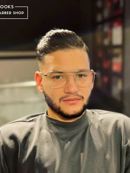 A great haircut complements your features. This pompadour fade is styled to perfection, framing the face and enhancing the client's look.