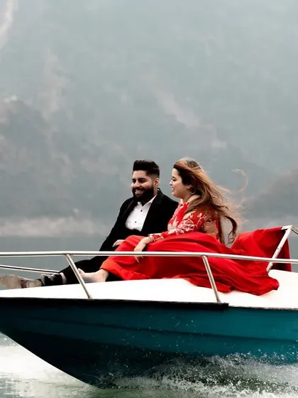 An action shot of the couple on a speedboat in Tehri, capturing the excitement and adventure of their destination pre-wedding experience.