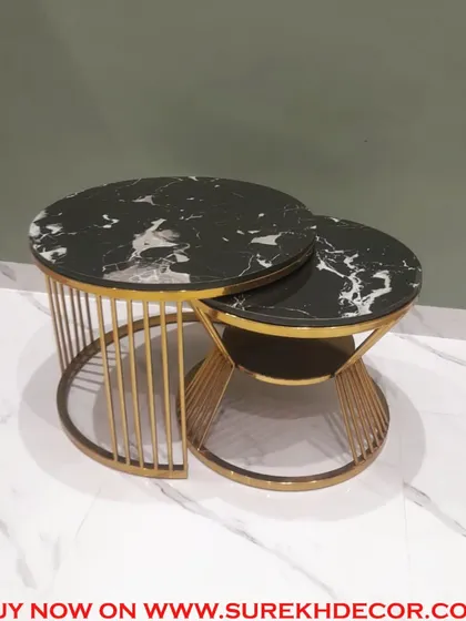 This set of two nesting center tables features a stunning black marble top with white veining. The gold electroplated steel base adds a touch of luxury, and the design can be customized to fit your space.