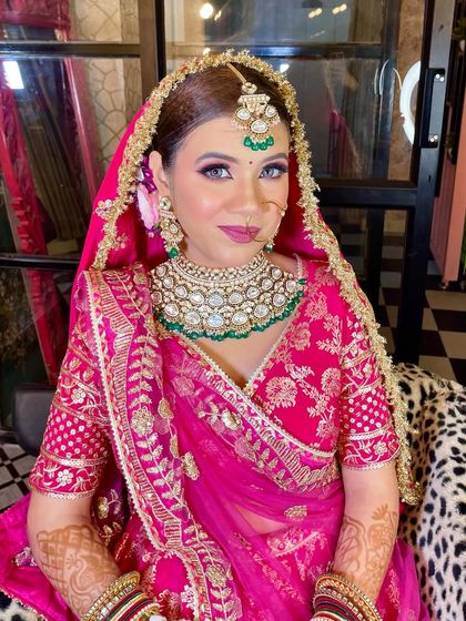 A portrait of my bride, showcasing her flawless makeup and the intricate details of her pink lehenga and kundan jewelry.