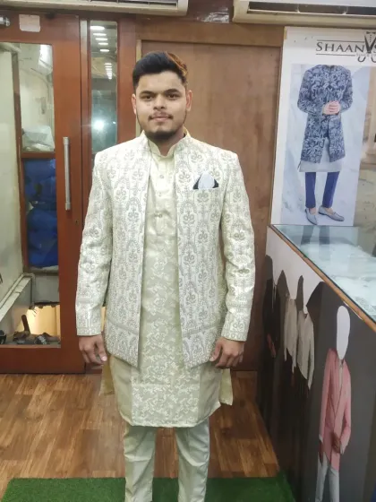 This client is pictured in our studio wearing a light-colored Jodhpuri suit. The ensemble includes a patterned jacket, a matching inner kurta, and churidar pants, all tailored for a flawless fit.
