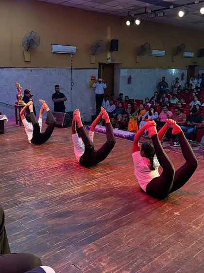 A powerful display of back-bending with the bow pose, performed in unison by my talented students during a stage show.
