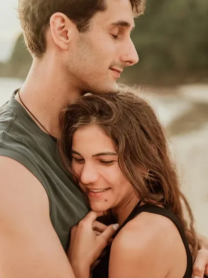 A close, affectionate hug on the beach, capturing a moment of comfort and love. This intimate portrait is a beautiful memory from their Bali pre-wedding shoot.