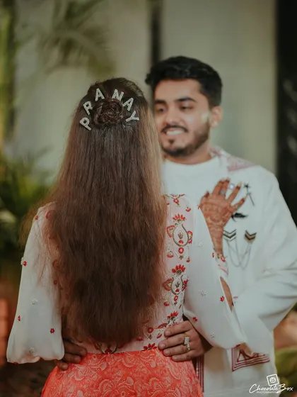 A sweet, personalized detail. The bride's custom hairpins spell out the groom's name, a small touch that we love to incorporate to make the day uniquely theirs.