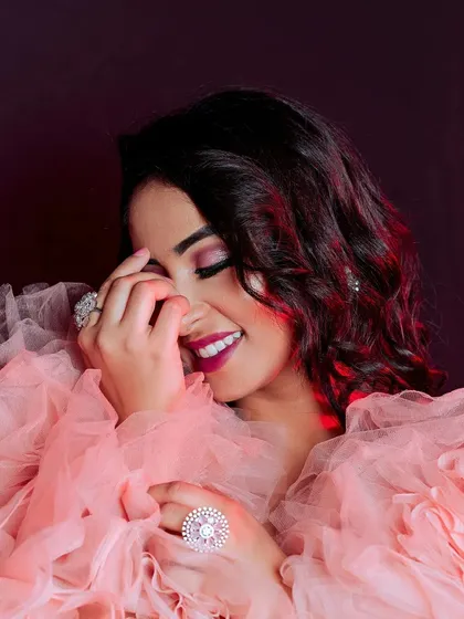 This candid portrait captures the elegance of a modern look. We used dramatic studio lighting with red highlights to complement the model's expression and the soft texture of the pink tulle outfit, creating a powerful image for a portfolio or brand campaign.