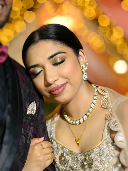 A reception look that's pure elegance. We added a touch of green shimmer to her eyes to complement her outfit, keeping the rest of the makeup minimal and glowing.