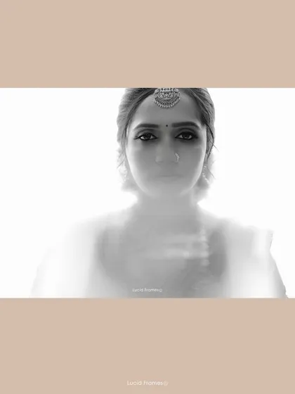 An artistic, ethereal black and white portrait of a South Indian bride, using soft focus to create a dreamlike quality.