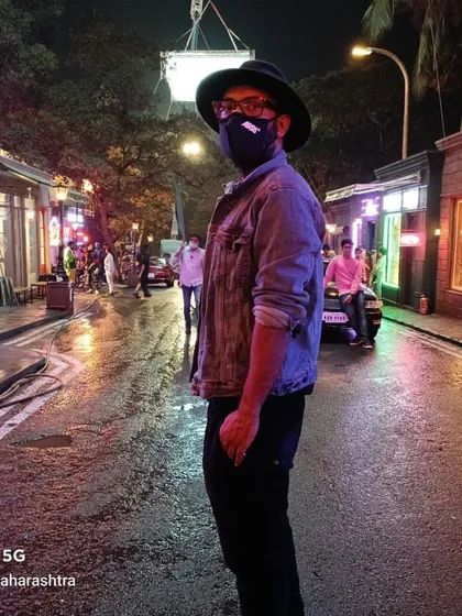 Cinematographer Tapan Basu inspects the lighting on a night shoot for a TVC. In the background, a powerful Creamsource SpaceX is rigged on a truss and suspended from a crane to provide a high, motivated light source for the street scene.