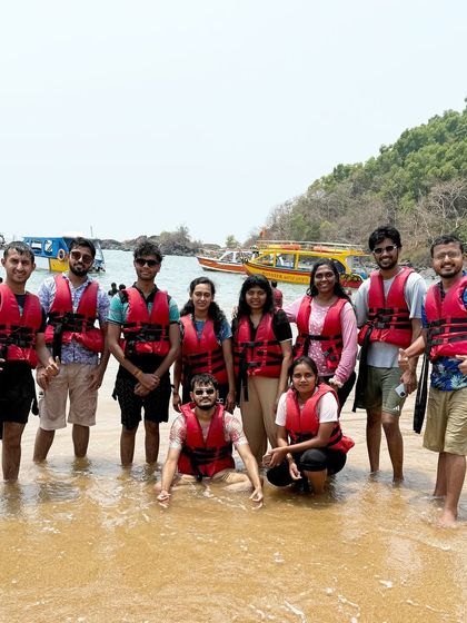 Our group ready for a swim, posing with their life jackets on the beach. Safety and fun go hand in hand.