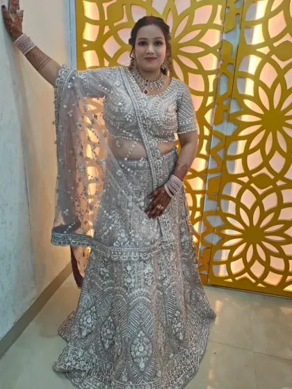This heavily embroidered silver-grey lehenga is a stunning choice for a reception or engagement. The intricate threadwork and pearl detailing offer a modern yet regal feel.