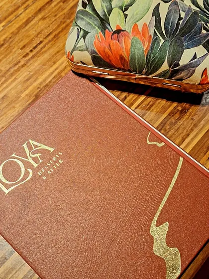 The dessert menu at Loya, paired with a beautiful clutch. The details matter in fine dining.