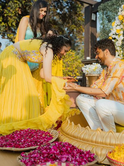 A playful moment where the bride applies Haldi to the groom. These fun, interactive moments are a key part of the celebration.