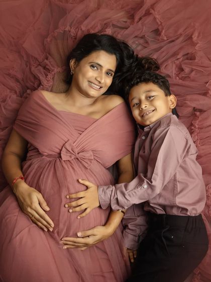 A sweet moment from above. This aerial shot of you and your son lying on the flowing gown is creative, fun, and full of love.
