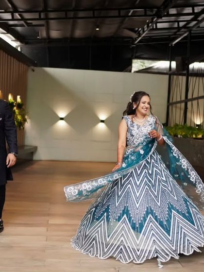 A joyful, twirling shot of the bride in her stunning lehenga during her engagement party.